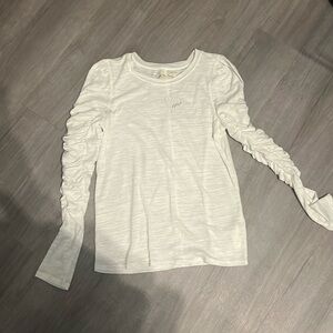 Free People white long sleeve top with bubbled sleeves.